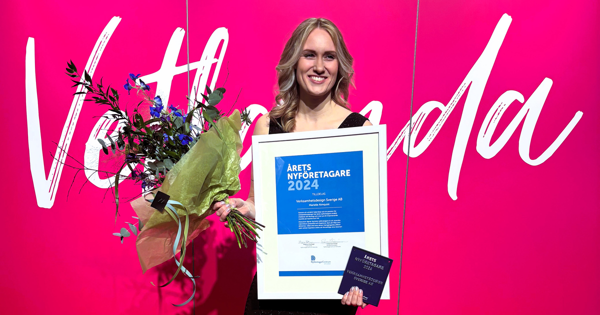 En kvinna håller i en bukett blommor och ett diplom som det står Årets Nyföretagare 2024 på.